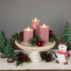 christmas candles and decorations on a table