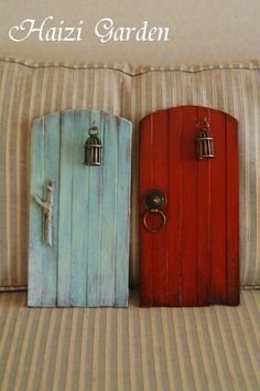 two wooden doors sitting on top of a bed next to each other in front of a pillow