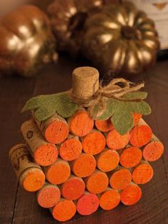 a pumpkin made out of wine corks on a table