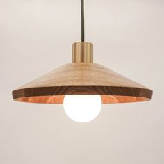 a wooden light fixture hanging from a ceiling with a white wall in the back ground