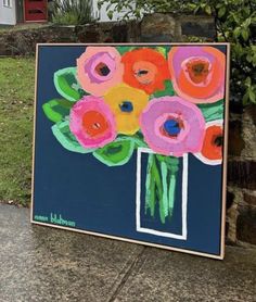 a painting on the ground with flowers in it