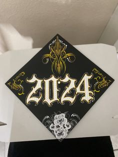 a black and gold graduation cap with the word class on it