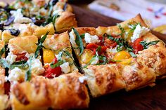 several slices of pizza on a wooden cutting board