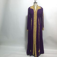 Royal plum purple hostess gown with elaborately stitched gold soutache from the 1960s. Vintage loungewear full length gown has no labels, likely purchased on a trip abroad to the Middle East or the Mediterranean. Midweight polyester knit with a nice amount of give. Back zipper. Maker not known, handmade by a tailor Material synthetic knit Care dry clean Suggested modern size Curvy 10 (please check measurements for accurate fit) measurements (taken flat then doubled) Bust 33" Waist 33" Hip 34" Sl Purple Long Maxi Dress For Evening, Elegant Purple Evening Kaftan, Long Sleeve Purple Party Kaftan, Purple Floor-length Abaya, Elegant Purple Floor-length Kaftan, Elegant Floor-length Purple Kaftan, Elegant Purple Embroidered Kaftan, Elegant Embroidered Purple Kaftan, Purple Long Sleeve Wedding Abaya