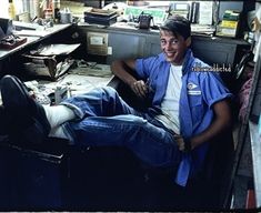 a man sitting in an office with his feet up on the desk