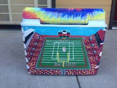 a painted cooler with a football field on it