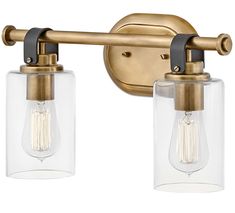 two light bathroom fixture with clear glass shades on the bulbs and brass finish, one bulb is