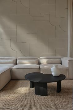 a living room with white couches and a black coffee table