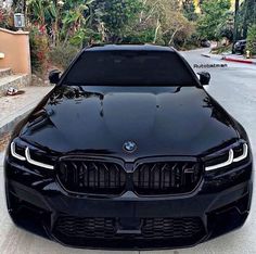 the front end of a black bmw car