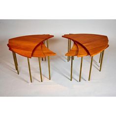 three wooden tables with brass legs and curved tops on white background, set of 3