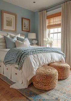 a large bed sitting in a bedroom next to two baskets on top of a rug