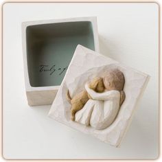 a ceramic figurine in a gift box