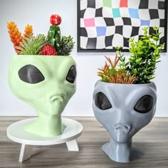 two alien planters sitting next to each other