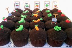 chocolate cupcakes with green frosting and decorations on them are arranged in rows