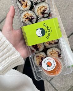 a person holding a plastic container filled with food