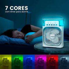 a woman laying in bed next to an alarm clock with colorful lights on the side