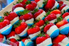 a box filled with red, white and blue strawberries on top of each other