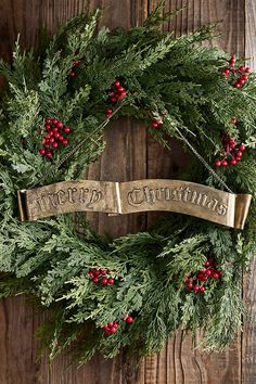 a christmas wreath hanging on a wooden wall