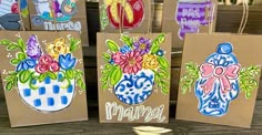 three bags decorated with flowers are sitting on a table