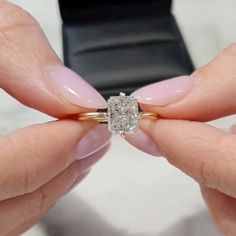 a woman's hands holding an engagement ring