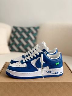 Embrace iconic style with these statement-making sneakers inspired by the legendary Louis Vuitton x Nike Air Force 1 collaboration. The vibrant blue leather upper, accented with the signature Louis Vuitton monogram, exudes luxury and street-style cool. Off-White™-inspired details add a contemporary edge, like the quoted "AIR" branding and exposed stitching. Step into the spotlight with these coveted kicks that blend high-fashion and sneaker culture. Your order arrives in a branded shoe box, comp Air Force 1 Louis Vuitton, Sneaker Culture, Baskets Nike, Iconic Style, Air Force 1 Low, Blue Sneakers, Vibrant Blue, Botswana, Nike Air Force 1