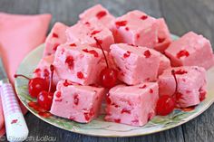 cherry chip fudge cake on a plate with cherries around it and text overlay that reads cherry chip fudge