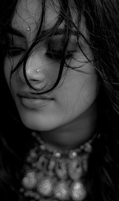 black and white photograph of a woman's face with her hair blowing in the wind