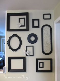 there are many black and white frames on the wall