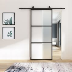 an open sliding door in a living room with pictures on the wall and rug underneath it