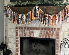 a fireplace decorated for halloween with pumpkins and leaves