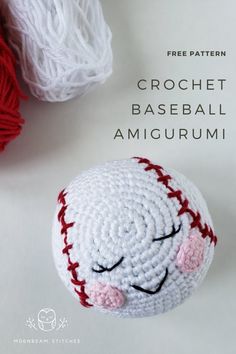 the crochet baseball amigurmi is laying next to two balls of yarn