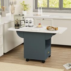 a kitchen island with food on it in the middle of a flooring area next to a window