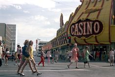 people crossing the street in front of a casino