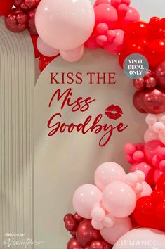 kiss the miss goodbye sign surrounded by red and pink balloons in front of a white background