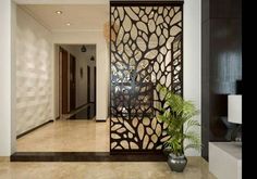 an entry way with a decorative screen and potted plant