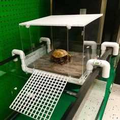 an image of a turtle basking platform in the process of being installed into a tank