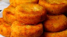 a pile of fried pastries sitting on top of a white plate with the words twisted above it