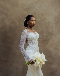 a woman in a wedding dress holding a bouquet