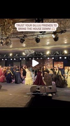 a group of people standing on top of a stage in front of a crowd with words above them that read trust your guju friends to bring the house down