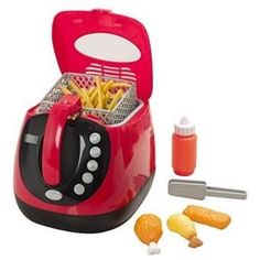 a red and black toaster with french fries in it next to some condiments