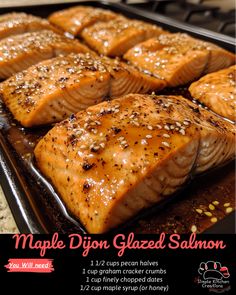 salmon fillets on a baking sheet with sesame seeds and seasoning in the middle