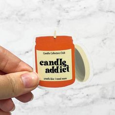 someone is holding up a candle that says candle adject on the front and side