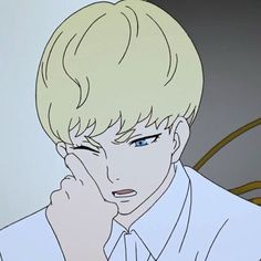 a man with blonde hair and blue eyes is looking at something in the distance while holding his hand to his face