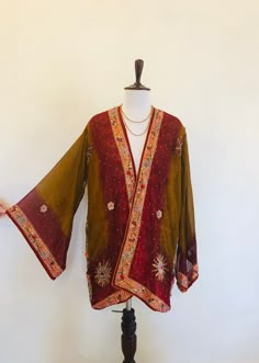 "A Stunning Sequinned and Beaded Silk Boho Kimono Jacket. Vintage 60s 70s hippie chic; a Perfect cover up for Holidays,Festivals and Evening Parties. This is Handmade from an Indian Sari. so completely Unique and Sustainable. A Wonderfully Chic and Flattering Deep Red and Copper Ombre silk ChiffonJacket, Beautifully embellished allover, and lined in silk. The jacket is exquisitely decorated with Golden lurex embroidery and 1000's of GlitteringSequins,Bugle Beads and Crystals that catch the Light Traditional Fitted Embellished Outerwear, Fitted Traditional Embellished Outerwear, Bohemian Outerwear For Festive Wedding, Bohemian Long Sleeve Outerwear For Wedding, Bohemian Outerwear For Fall Wedding, Bohemian Long Sleeve Wedding Outerwear, Embellished Long Sleeve Silk Outerwear, Embroidered Bohemian Outerwear For Weddings, Traditional Embellished Outerwear For Parties