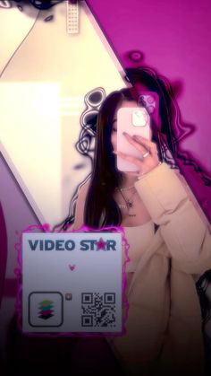 a woman taking a selfie in front of a video star sign with her cell phone