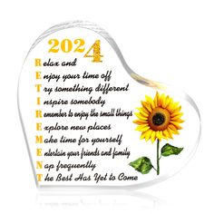 a glass heart shaped plaque with a sunflower on the front and words below it