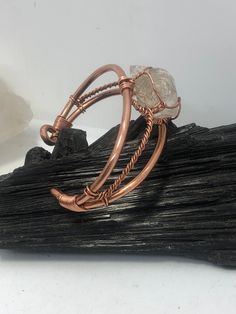 This original wire wrapped wearable wrist piece is a step in our evolutionary process as well as a new page in our revolutionary archive of original hand crafted wearable works. The gems are wrapped with our secure time tested low profile technique designed to highlight the stone, offer access to touch the gems surface, and fit comfortably on various body types. A solid copper bangle stabilizes the gems in a symmetric pattern, synchronizing the metal and stones in such a way that the piece gives Eyesight Improvement, Symmetric Pattern, Wire Weaving Techniques, Copper Wire Art, Wire Jewelry Patterns, Copper Work, Wrap Bangles, 2024 Design, Wire Jewelry Designs