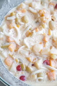 a close up of a plate of food with fruit and cream toppings on it