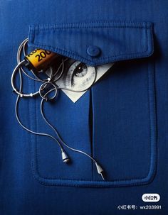 a blue jacket with earphones attached to it and an mp3 player sticking out of the pocket