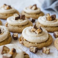 there are many cookies with white frosting on the table